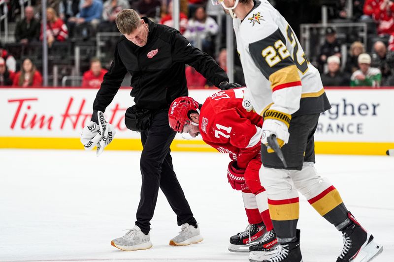A Detroit Red Wings staff checks on center Dylan Larkin (71) after a play against Vegas Golden Knights during the third period at Little Caesars Arena in Detroit on Wednesday, March 4, 2026.