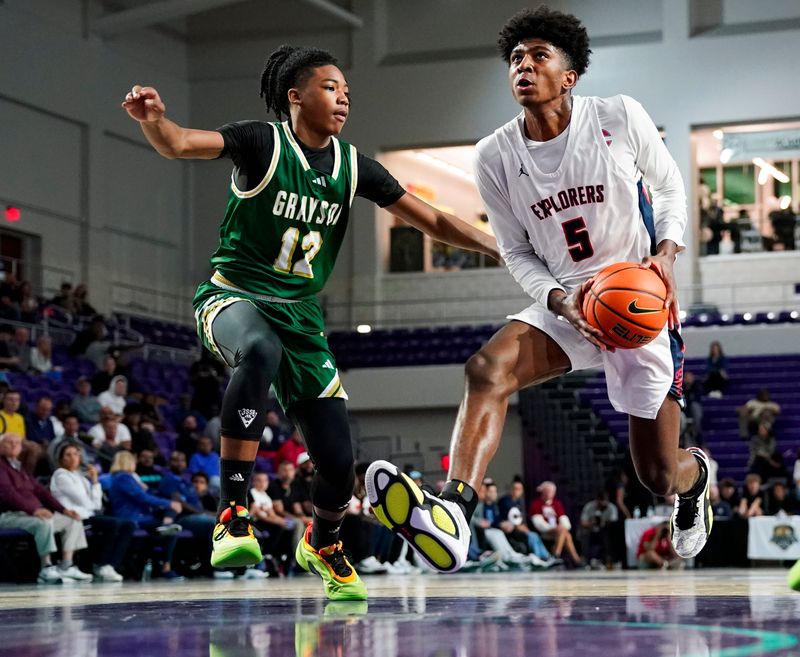 Columbus Explorers guard Jaxon Richardson (5) drives to the basket as Grayson Rams guard Blaze Johnson (12) guards him during the third quarter of a City of Palms Classic quarterfinal game at Suncoast Credit Union Arena in Fort Myers, Fla., on Friday, Dec. 20, 2024.