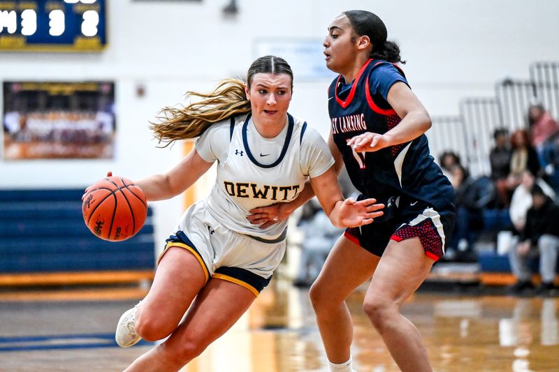 DeWitt's Carly Dennis, left, moves the ball as East Lansing's Sydney Black defends during the fourth quarter on Friday, March 6, 2026, at Grand Ledge High School.