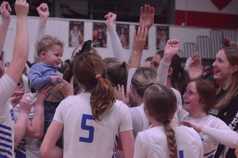 The Inland Lakes girls basketball team celebrates winning a fourth consecutive MHSAA Division 4 district title after winning at Onaway on Friday, March 6.