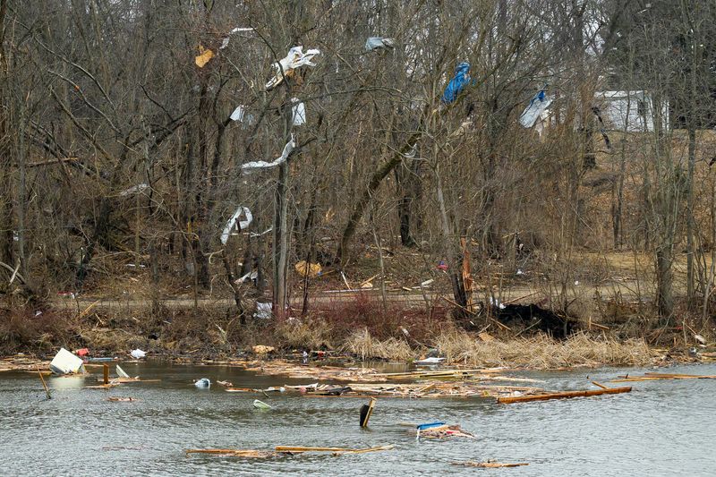 Debris hangs from trees along in Union Lake in Union City on Saturday, March 7, 2026 after the area was hit by a tornado the day before.