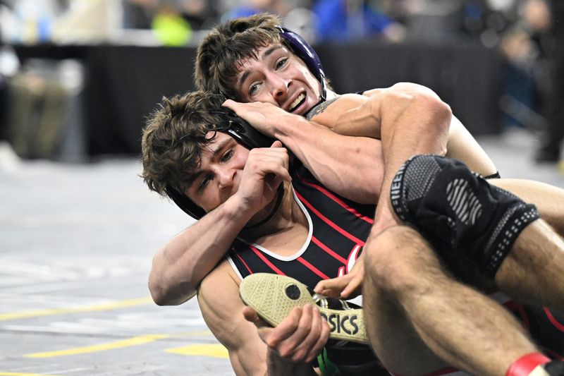 Louis Smith of Three Rivers, top, wrestles Seth Harvery of Lowell in the Division 2 175-pound class. Smith won by decision 6-5. Smith’s mother, Gina Smith, said the recent tornado missed their family home by less than a mile.