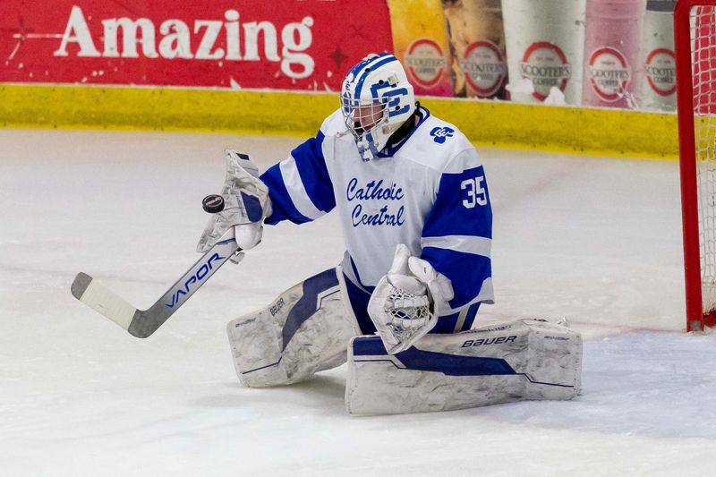 Nick Kogut (35) of Detroit Catholic Central makes a save against the Northville Mustangs during the first period.