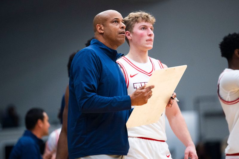 Detroit Mercy coach Mark Montgomery and TJ Nadeau II talk during a NCAA men's basketball game during the 2025-26 season.
