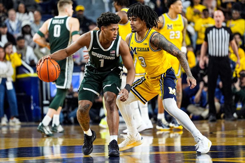 Michigan State guard Jeremy Fears Jr. (1) dribbles against Michigan guard Elliot Cadeau (3) during the first half at Crisler Center in Ann Arbor on Sunday, March 8, 2026.