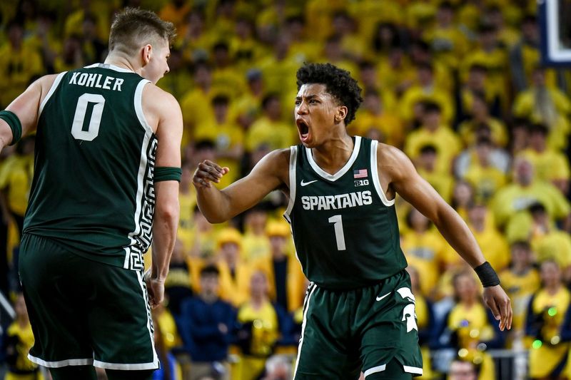 Michigan State's Jeremy Fears Jr., left, celebrates with Jaxon Kohler after Kohler's 3-pointer against Michigan during the first half on Sunday, March 8, 2026, at the Crisler Center in Ann Arbor.