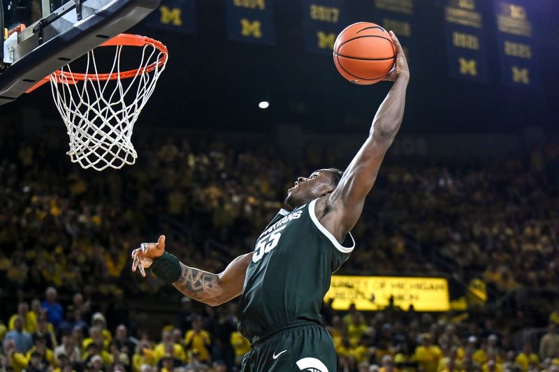 Michigan State's Coen Carr dunks against Michigan during the second half on Sunday, March 8, 2026, at the Crisler Center in Ann Arbor.