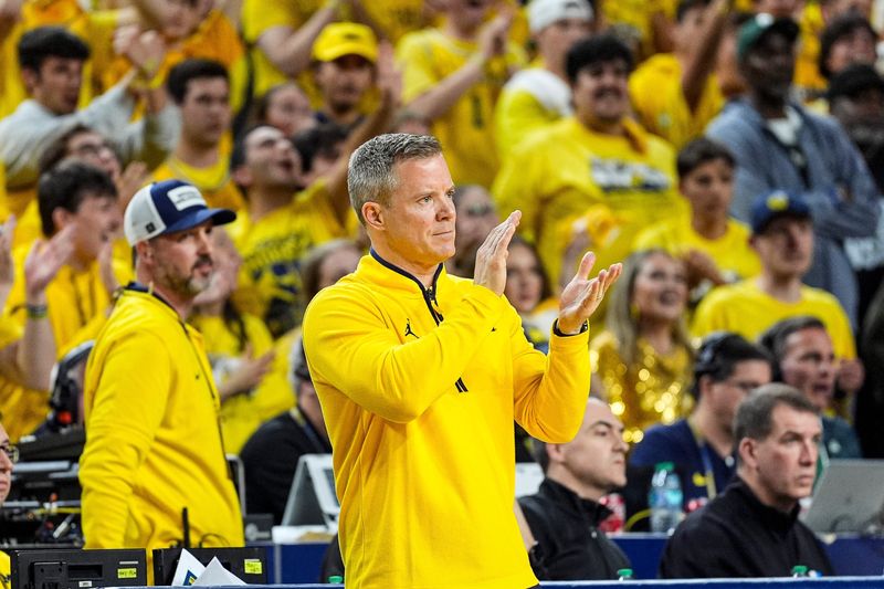 Michigan head coach Dusty May applauds for a play against Michigan State during the second half at Crisler Center in Ann Arbor on Sunday, March 8, 2026.
