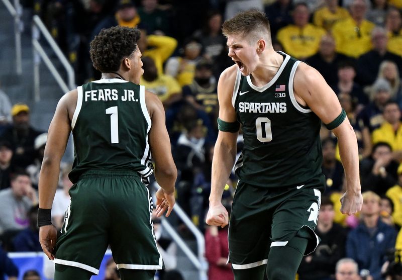 Michigan State guard Jeremy Fears Jr. (1) and forward Jaxon Kohler react after a basket in the first half against Michigan on Sunday, March 8, 2026, at Crisler Center in Ann Arbor.