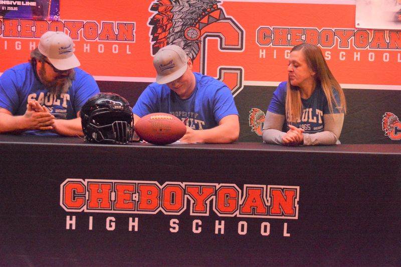 Alongside his parents, Richard and Natalie Wichlacz, Cheboygan senior Troy Wichlacz signed to play football for Sault College (Ontario) during a ceremony at Cheboygan's High School auditorium on Monday, March 9.