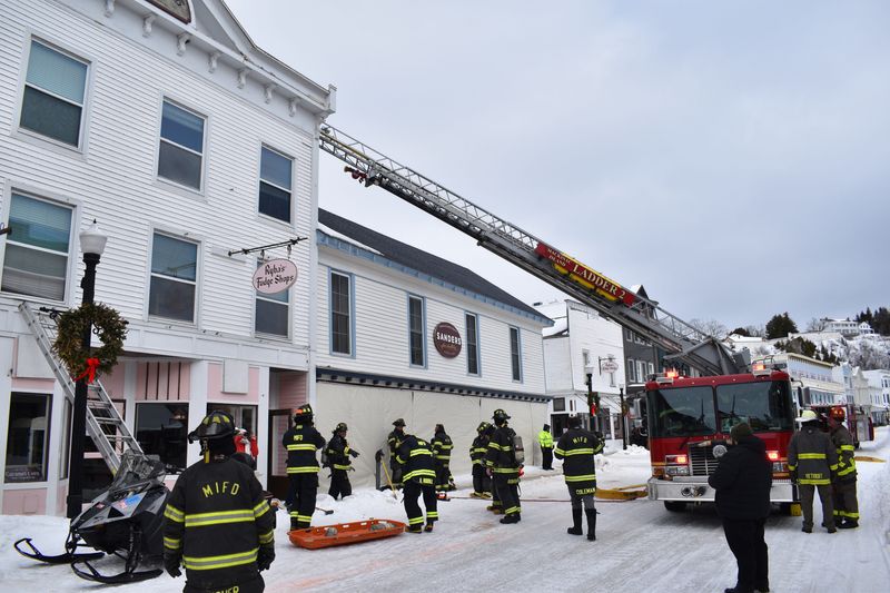 Mackinac Island firefighters working with Detroit Fire Department firefighters prepare to enter a building on Main Street, Mackinac Island, during a drill on Saturday, Feb. 28, 2026.