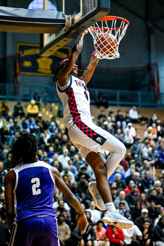 East Lansing's Tyree Anthony dunks against Ann Arbor Pioneer during the third quarter on Tuesday, March 10, 2026, at the Don Johnson Fieldhouse in Lansing.