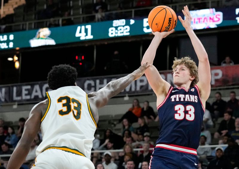 Detroit Mercy Titans guard TJ Nadeau (33) shoots the ball against Wright State Raiders forward Michael Imariagbe (33) on Tuesday, March 10, 2026, at Corteva Coliseum at the Indiana State Fairgrounds in Indianapolis. The Wright State Raiders defeated the Detroit Mercy Titans, 66-63 to win the Horizon League Championship.