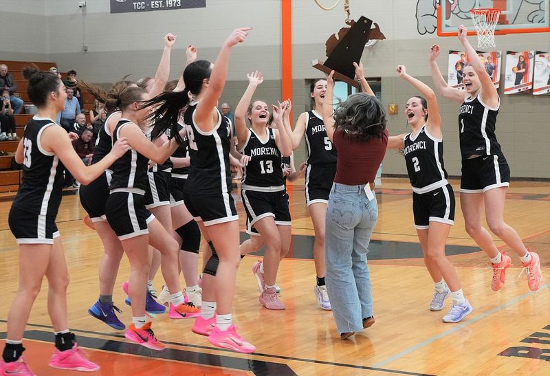 The Morenci Bulldogs celebrate their third straight Division 4 Regional Championship Wednesday night at Summerfield