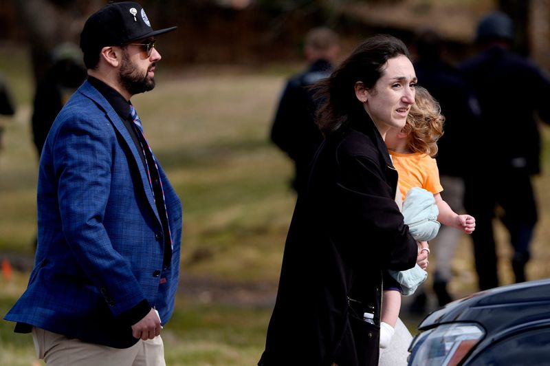 Parents walk to their cars after reuniting with their children at Temple Israel in West Bloomfield on Thursday, March 12, 2026.
