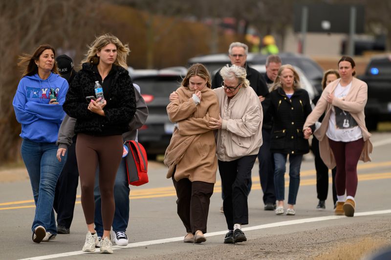 Families are escorted by authorities away from Temple Israel after an active shooter situation inside the synagogue, in West Bloomfield, March 12, 2026.