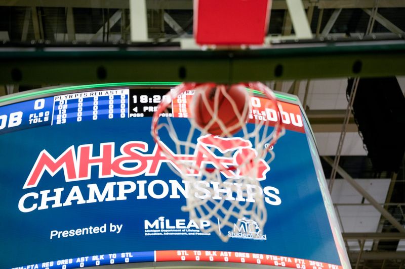 A ball falls into a basket during warmups for the MHSAA Division 4 semifinals between Detroit Douglass and Dollar Bay at Breslin Center in East Lansing on Thursday, March 12, 2026.