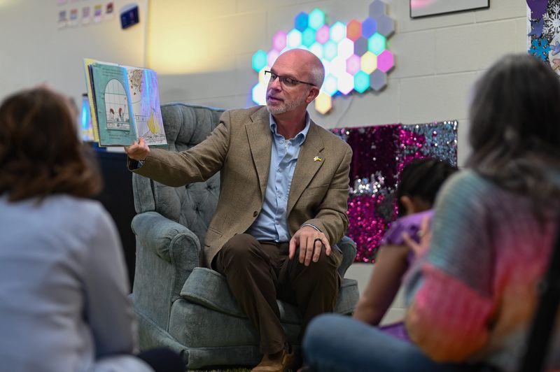 Okemos Public Schools Superintendent John Hood reads to students, Friday, March 13, 2026, at Bennett Woods Elementary school in Okemos. Hood will be retiring after 30 years in the district.