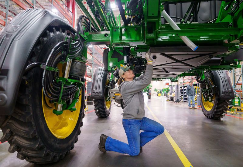 Wyndi Gray attaches a belly shield to a sprayer at the John Deere Des Moines Works in Ankeny, Feb. 24, 2026.