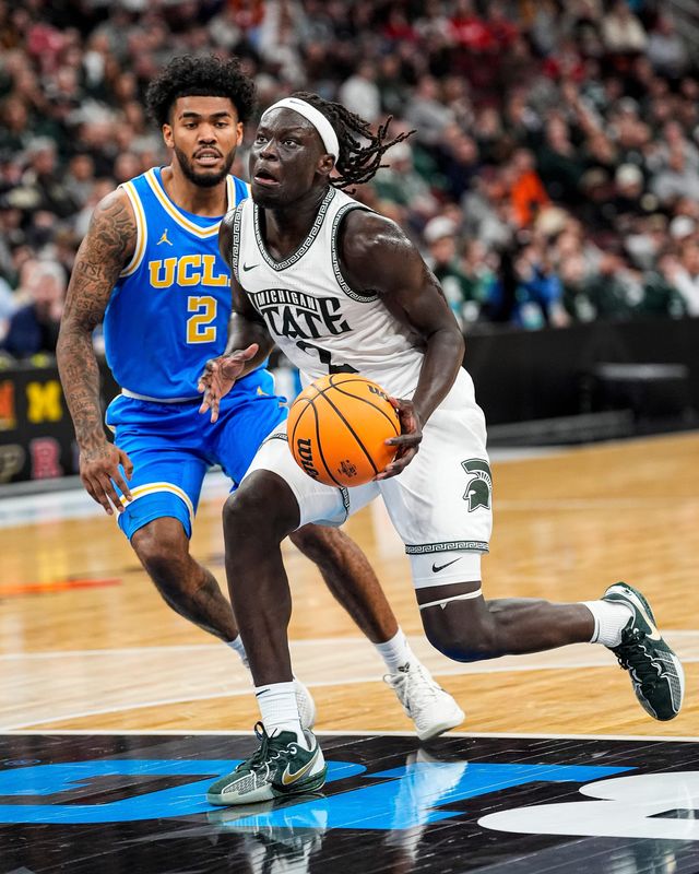 Michigan State guard Kur Teng (2) dribbles against UCLA guard Donovan Dent (2) during the first half of Big Ten tournament quarterfinal at United Center in Chicago on Friday, March 13, 2026.