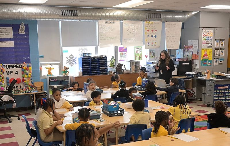 Teacher Kathleen Vitale works with her kindergarten students in a classroom with heat and air from ceiling ducts at Bates Academy, part of Detroit Public Schools Community District's $700 million in building projects, in Detroit, Michigan, on March 3, 2026.