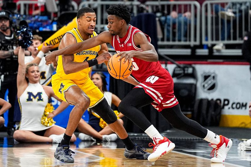 Wisconsin guard John Blackwell (25) dribbles against Michigan guard Nimari Burnett (4) during the first half of Big Ten Tournament semifinal at United Center in Chicago on Saturday, March 14, 2026.