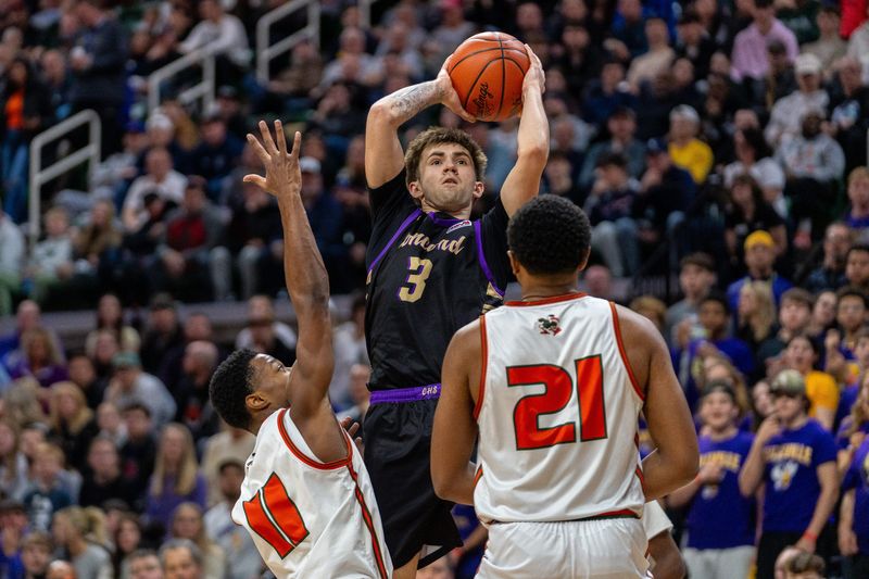 Concord’s Jett Smith (3) shoots over Detroit Douglass defenders during the MHSAA Division 4 boys basketball state championship game at the Breslin Center in Lansing on Saturday, March 14, 2026.