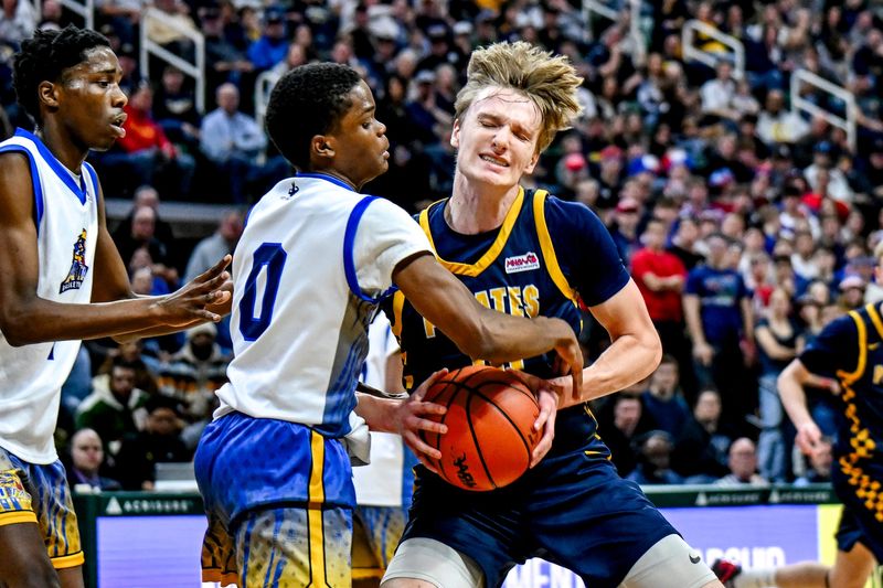 Pewamo-Westphalia's Grady Eklund, right, is pressured by ATAP's Lewis Lovejoy during the second quarter of the D3 boys basketball state final on Saturday, March 14, 2026, at the Breslin Center in East Lansing.