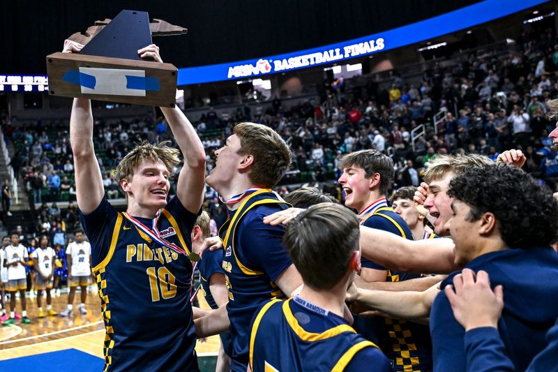 Pewamo-Westphalia's Grady Eklund, left, and the team celebrates with the D3 boys basketball championship trophy after defeating ATAP on Saturday, March 14, 2026, at the Breslin Center in East Lansing.