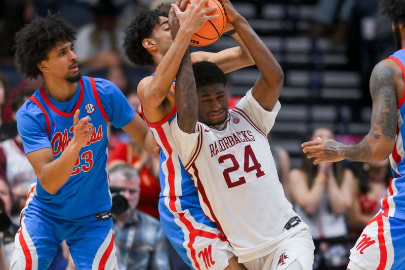 Arkansas Razorbacks forward Billy Richmond III (24) and Mississippi Rebels guard Ilias Kamardine (6) fight for the loose ball during the second half.