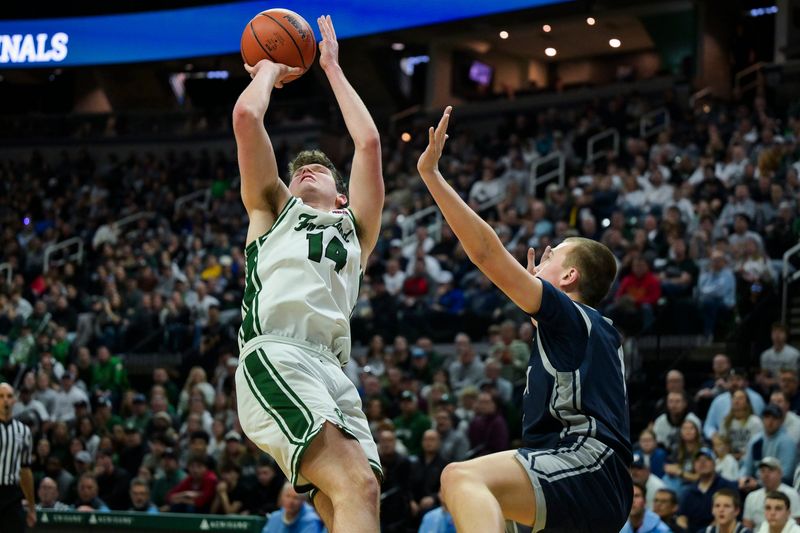 Freeland's Wilson Huckeby takes a shot while Hudsonville Unity Christian's Owen VanderWaal guards him during their Div. 2 state final on Saturday, March 14, 2026 at the Breslin Center in East Lansing.