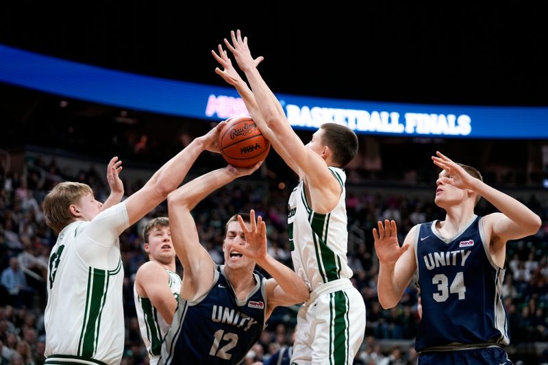 Hudsonville Unity Christian's Owen VanderWaal (12) attempts a shot as Freeland players defend him during the MHSAA Div. 2 finals at the Breslin Center in East Lansing, on Saturday, March 14, 2026.