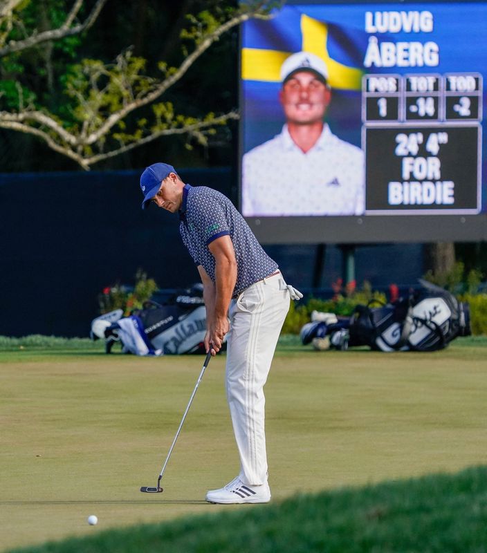 Ludvig Aberg putts for birdie on the 14th green during the third round of THE PLAYERS Championship.