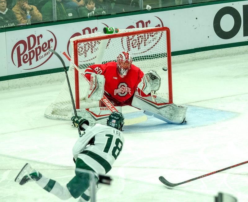 MSU's Ryker Lee (18) takes a shot on goal as Ohio State's Kristoffer Eberley makes the save Saturday, March 14, 2026 at Munn Arena