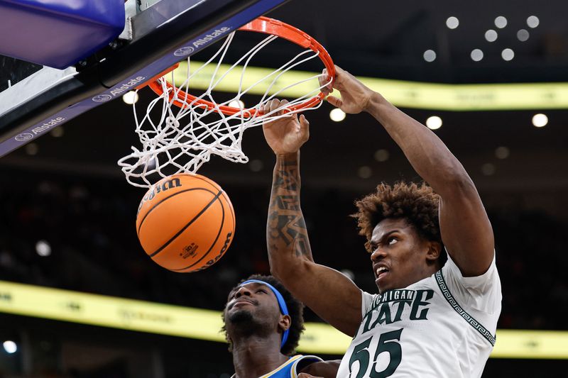 Mar 13, 2026; Chicago, IL, USA; Michigan State Spartans forward Coen Carr (55) scores against the UCLA Bruins during the second half at United Center. Mandatory Credit: Kamil Krzaczynski-Imagn Images