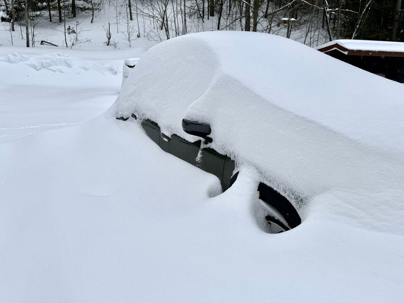 A car is seen buried in snow in Petoskey on Monday, March 16, 2026.