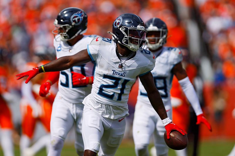 Titans cornerback Roger McCreary #21 celebrates an interception during the first quarter against the Broncos during a game in 2025 at Empower Field At Mile High in Denver, Col.
