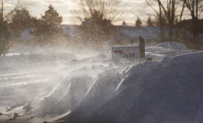 Snow blows across the road on Monday, March 16, 2026, in Ledgeview, Wis. A winter storm dumped about 2 feet of snow throughout the region between Saturday and Monday.