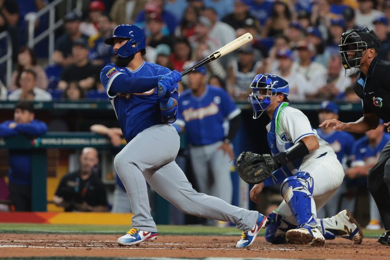 Tigers second baseman Gleyber Torres (25) hits a single for Venezuela against Italy in the second inning during a semifinal game of the 2026 World Baseball Classic at loanDepot Park.