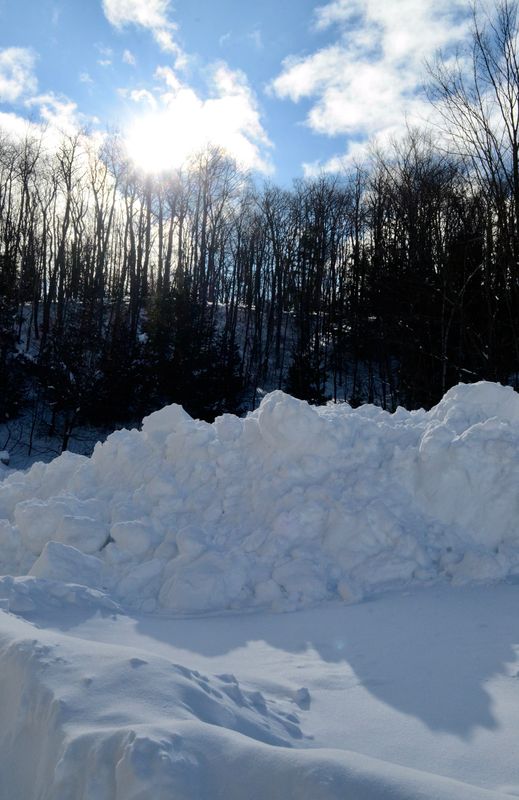 Piles of snow are seen under sunny skies on March 17, 2026 in Petoskey.