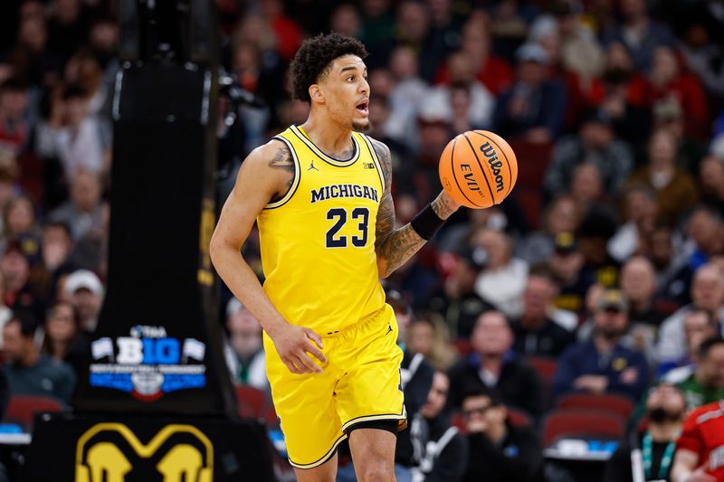 Mar 14, 2026; Chicago, IL, USA; Michigan Wolverines forward Yaxel Lendeborg (23) passes the ball against the Wisconsin Badgers during the second half at United Center. Mandatory Credit: Kamil Krzaczynski-Imagn Images