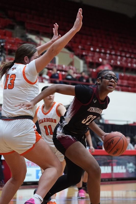 Detroit Renaissance’s Jayla Adams (32) drives the ball against Dearborn’s Zeinab Homayed (13) during the second half of the MHSAA Girls basketball division 1 quarterfinals at Calihan Hall in Detroit, Tuesday, March 17, 2026.