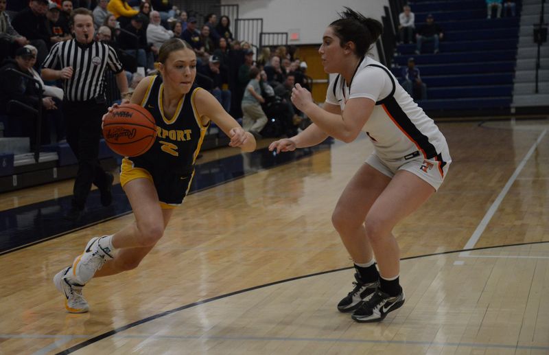 Olivia Gratz of Airport drives on Tecumseh's Maya Juozapartis during a 75-44 Tecumseh win in the Division 2 state quarterfinals at Chelsea on Tuesday, March 17, 2026.