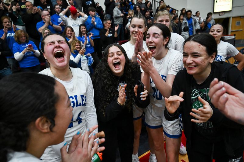 Utica Eisenhower players celebrate after their 57-43 Div. 1 state quarterfinal victory over Fraser on Tuesday, March 17, 2026 in Detroit.
