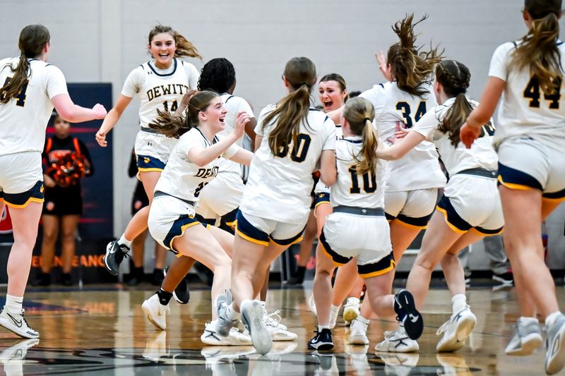 DeWitt celebrates after defeating Belleville in the Division 1 girls basketball state quarterfinal on Tuesday, March 17, 2026, at Mason High School.