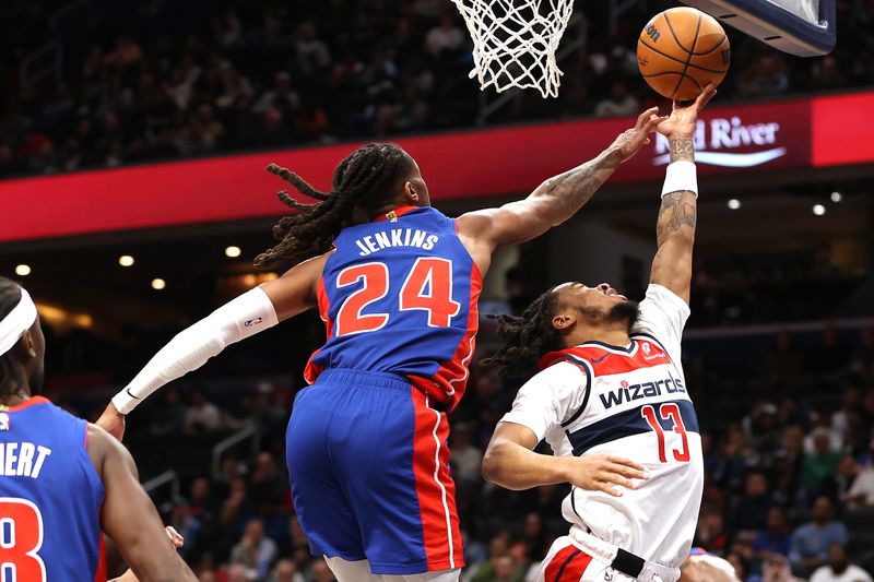 Detroit Pistons guard Daniss Jenkins (24) swats the ball away from Washington Wizards guard Sharife Cooper (13) during the second half at Capital One Arena in Washington on Tuesday, March 17, 2026.