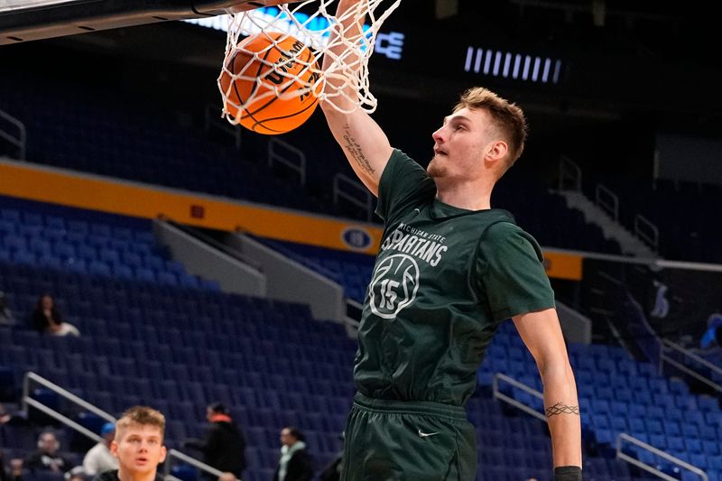 Mar 18, 2026; Buffalo, NY, USA; Michigan State Spartans center Carson Cooper (15) dunks the ball during a practice session ahead of the first round of the men's 2026 NCAA Tournament at Keybank Center. Mandatory Credit: Gregory Fisher-Imagn Images