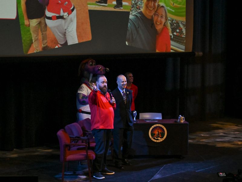 Lansing Lugnuts General Manager Zac Clark, left, speaks to audience members before Lansing Mayor Andy Schor gave his 2026 State of the City address, Wednesday, May 18, 2026, at Dart Auditorium on the campus of Lansing Community College.