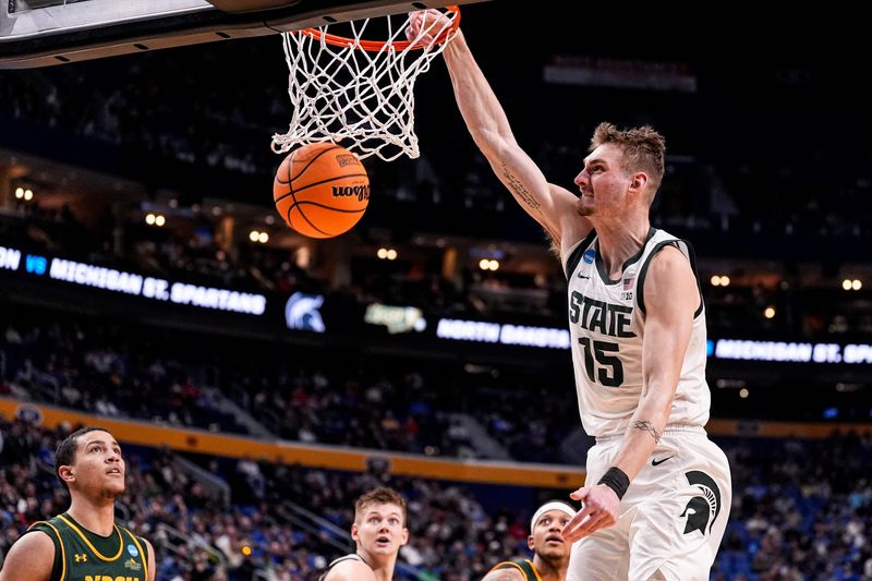 Michigan State center Carson Cooper (15) dunks against North Dakota State during the second half of NCAA Tournament First Round at KeyBank Center in Buffalo on Thursday, March 19, 2026.