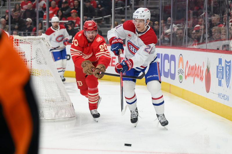 Detroit defenseman Albert Johansson tries to steal the puck away from Montréal defenseman Kaiden Guhle during the first period of a game between the Detroit Red Wings and the Montreal Canadiens, at Little Caesars Arena, in Detroit, March 19, 2026.